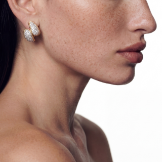 gold earring featuring brilliant-cut diamonds worn