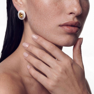Gold and white enamel earring with heliodorus and diamonds worn