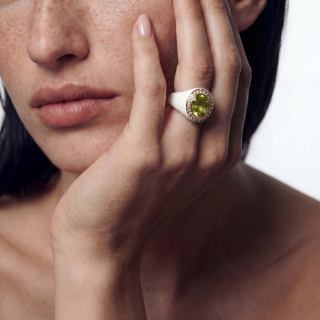 Yellow Gold Ring with white enamel, peridot and diamonds worn