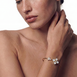 gold bracelets featuring hard stones and brilliant cut diamonds worn