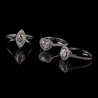 four-prong solitaire ring with a diamond border