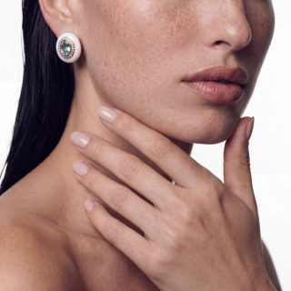 Gold and white enamel earring with aquamarine and diamonds worn