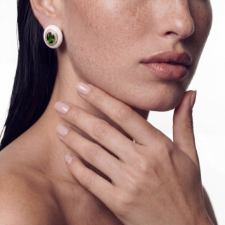 Gold and white enamel earring with diopside and diamonds worn